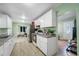 The open-concept kitchen has white cabinets, granite countertops, stainless steel appliances, and tiled floors at 317 Elizabeth Ave, Clearwater, FL 33759