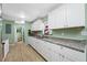 Bright kitchen featuring white cabinets, granite countertops, and modern appliances at 317 Elizabeth Ave, Clearwater, FL 33759