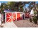 Backyard featuring a red barn-style shed with a small window and door, with pea gravel ground at 4106 N Central Ave, Tampa, FL 33603