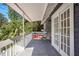 This outdoor balcony features two seats and a table, overlooking the surrounding foliage at 4106 N Central Ave, Tampa, FL 33603
