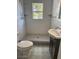 Modern bathroom featuring a walk-in shower with white tile surround and a window for natural light at 4106 N Central Ave, Tampa, FL 33603
