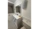 Updated bathroom featuring modern lighting, tiled shower, and vanity with ample storage at 4106 N Central Ave, Tampa, FL 33603
