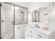 Modern bathroom features a frameless glass shower, white vanity, and updated fixtures at 4106 N Central Ave, Tampa, FL 33603