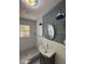 Stylish bathroom with unique lighting fixtures, a vanity sink, and a walk-in shower with decorative tile at 4106 N Central Ave, Tampa, FL 33603