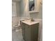 Well-lit bathroom featuring a vanity with a sink, a toilet, a window and a gray and white patterned floor at 4106 N Central Ave, Tampa, FL 33603