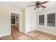 Light-filled bedroom with an ensuite bathroom features hardwood floors and a ceiling fan at 4106 N Central Ave, Tampa, FL 33603