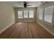 Well-lit bedroom featuring hardwood flooring, three windows and neutral walls at 4106 N Central Ave, Tampa, FL 33603