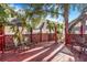 Red wood deck with chairs and lattice railing provides a great outdoor space for relaxation and enjoyment at 4106 N Central Ave, Tampa, FL 33603