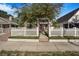 Charming home with white picket fence, lush landscaping, and inviting front porch detail at 4106 N Central Ave, Tampa, FL 33603