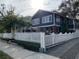 Charming two-story home with brick columns, white picket fence and mature landscaping at 4106 N Central Ave, Tampa, FL 33603