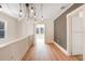 Hallway featuring wood floors, modern lighting, white trim, and natural light at 4106 N Central Ave, Tampa, FL 33603