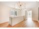 Hallway with wood floors, bright natural light, and an interesting modern chandelier at 4106 N Central Ave, Tampa, FL 33603