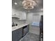 Modern kitchen with white upper cabinets, gray lower cabinets, and stainless steel appliances at 4106 N Central Ave, Tampa, FL 33603