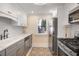 Well-lit kitchen with stainless appliances, stone countertops and modern cabinetry at 4106 N Central Ave, Tampa, FL 33603