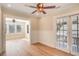 Open-concept living room with hardwood floors, ceiling fans and French doors at 4106 N Central Ave, Tampa, FL 33603