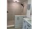 Walk-in shower featuring light-colored tiling and updated fixtures at 4106 N Central Ave, Tampa, FL 33603