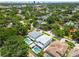 This aerial view shows the home nestled within a lush, established neighborhood with mature trees and nearby community amenities at 4109 W Inman Ave, Tampa, FL 33609