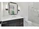 Elegant bathroom featuring a sleek vanity with a white countertop and a glass-enclosed shower at 4109 W Inman Ave, Tampa, FL 33609