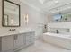 Bright bathroom featuring marble floors, dual vanity sinks, soaking tub and a walk-in shower at 4109 W Inman Ave, Tampa, FL 33609