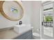 Contemporary bathroom features a vessel sink, modern faucet, and a view of the outdoor patio at 4109 W Inman Ave, Tampa, FL 33609