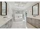 Bright bathroom with marble floors, dual vanity sinks, soaking tub and a walk-in shower at 4109 W Inman Ave, Tampa, FL 33609