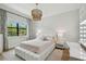 Bedroom with hardwood floors, a large window, and an elegant light fixture at 4109 W Inman Ave, Tampa, FL 33609