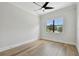 An empty bedroom with beautiful hardwood floors, a ceiling fan, and a large window that brings in tons of light at 4109 W Inman Ave, Tampa, FL 33609