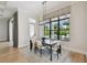 Elegant dining room with modern light fixture, and view to a pool and patio area at 4109 W Inman Ave, Tampa, FL 33609