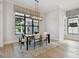 Inviting dining room with a modern light fixture, large windows, and a stylish area rug at 4109 W Inman Ave, Tampa, FL 33609
