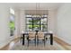 Charming dining room with modern chandelier and a large window with patterned shades at 4109 W Inman Ave, Tampa, FL 33609
