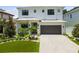 Elegant two-story home showcases a neutral palette, manicured landscaping, modern design, and a spacious two-car garage at 4109 W Inman Ave, Tampa, FL 33609