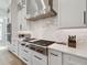 Close-up of gourmet stove and tile backsplash in a modern and bright kitchen at 4109 W Inman Ave, Tampa, FL 33609