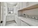 Bright laundry room features washer, dryer, ample white cabinetry, and a large window for an efficient space at 4109 W Inman Ave, Tampa, FL 33609