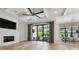 Spacious living room with a modern fireplace, large sliding glass doors, and an open view to the dining area at 4109 W Inman Ave, Tampa, FL 33609