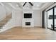 Bright living room featuring a decorative fireplace, hardwood floors, and large glass doors at 4109 W Inman Ave, Tampa, FL 33609