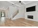 Open-concept living area with a fireplace, hardwood floors, and a staircase at 4109 W Inman Ave, Tampa, FL 33609
