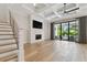 Bright living room with hardwood floors, fireplace, coffered ceiling, and sliding glass doors leading to a pool area at 4109 W Inman Ave, Tampa, FL 33609