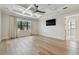Spacious main bedroom featuring hardwood floors, a tray ceiling, and large windows with natural light at 4109 W Inman Ave, Tampa, FL 33609