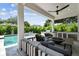 Covered patio featuring an outdoor kitchen, a modern fire pit, and stylish seating with a pool view at 4109 W Inman Ave, Tampa, FL 33609
