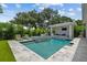 Inviting pool with spa, outdoor kitchen, and covered lounge area, perfect for entertaining at 4109 W Inman Ave, Tampa, FL 33609