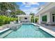 Inviting pool area features a spa, swim up bar, and covered lounge with outdoor kitchen, perfect for relaxation and entertaining at 4109 W Inman Ave, Tampa, FL 33609