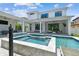 Spacious backyard with pool, spa, outdoor kitchen, and lounge area for outdoor entertaining at 4109 W Inman Ave, Tampa, FL 33609
