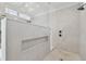 Walk-in shower featuring a stone floor, rain shower head, and tiled walls with a built-in shelf at 4109 W Inman Ave, Tampa, FL 33609