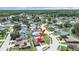 Aerial view showcases a home with mature trees, surrounding community, and a serene lake nearby at 4652 Swallowtail Dr, New Port Richey, FL 34653
