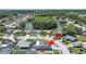 Scenic aerial view of a home near a lake and lush trees in a beautiful community setting at 4652 Swallowtail Dr, New Port Richey, FL 34653