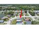 Residential home with a well-maintained landscape is shown in an aerial view of a quiet community with mature trees at 4652 Swallowtail Dr, New Port Richey, FL 34653