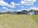 Large backyard with well-maintained grass and screened-in porch/pool at 4652 Swallowtail Dr, New Port Richey, FL 34653