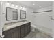 Bathroom featuring double sinks, granite countertops, and a glass-enclosed shower at 4652 Swallowtail Dr, New Port Richey, FL 34653