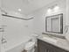 Bright bathroom with shower-tub combo, updated vanity, and modern fixtures at 4652 Swallowtail Dr, New Port Richey, FL 34653