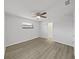 Clean bedroom with light gray walls, a ceiling fan, vinyl flooring, and a closet at 4652 Swallowtail Dr, New Port Richey, FL 34653